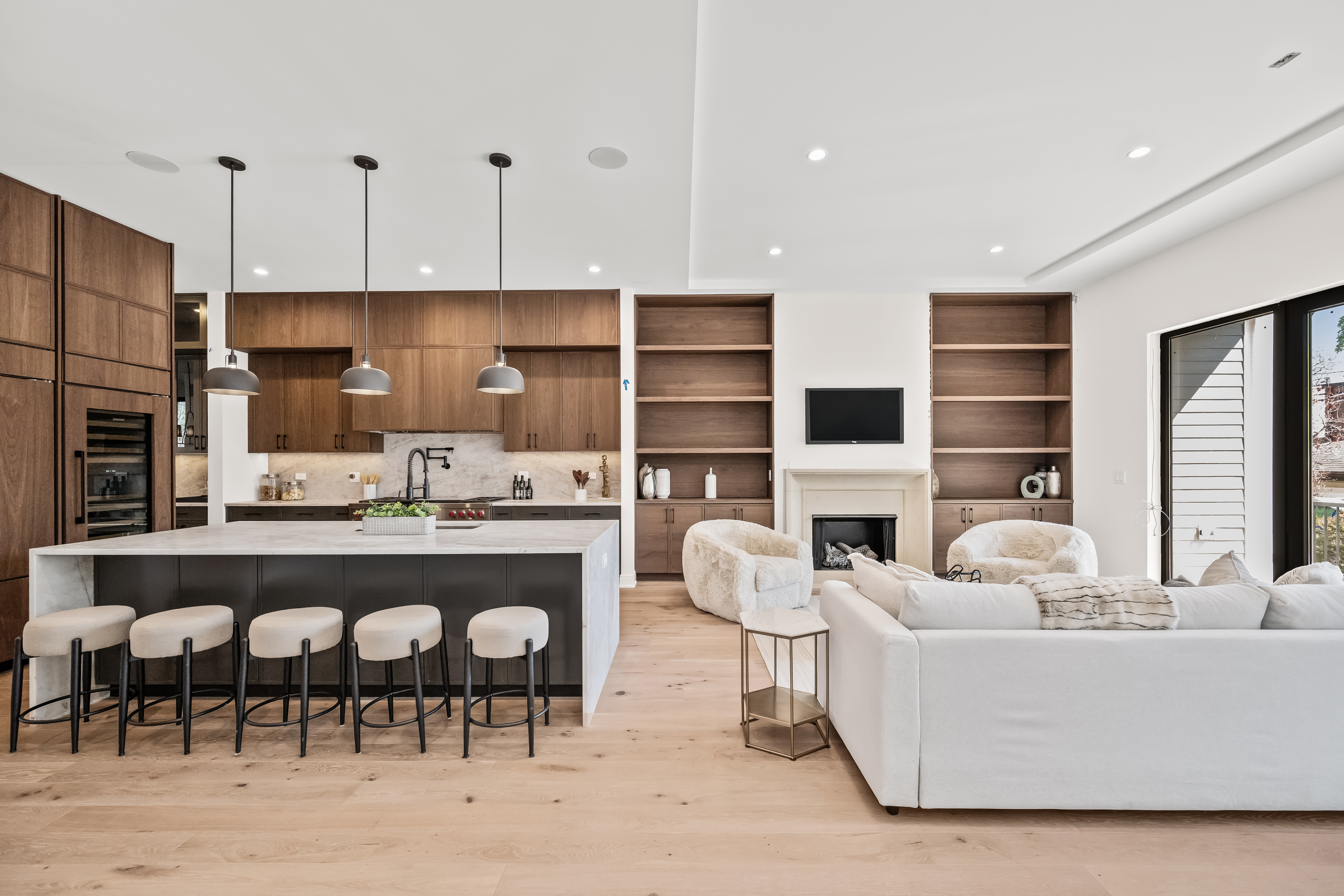 Kitchen with walnut cabinetry and stone island
