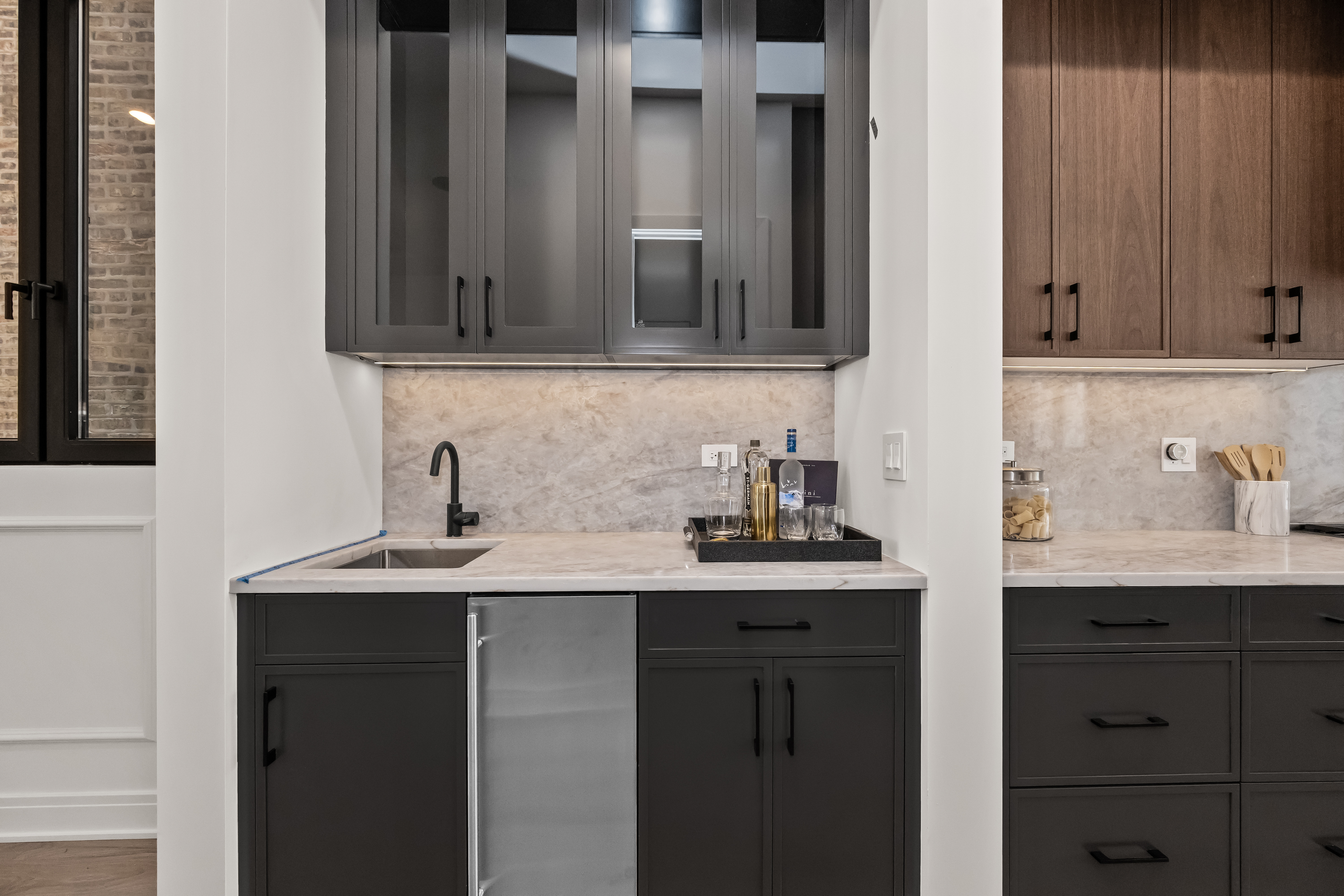 Butler's pantry with dark cabinetry