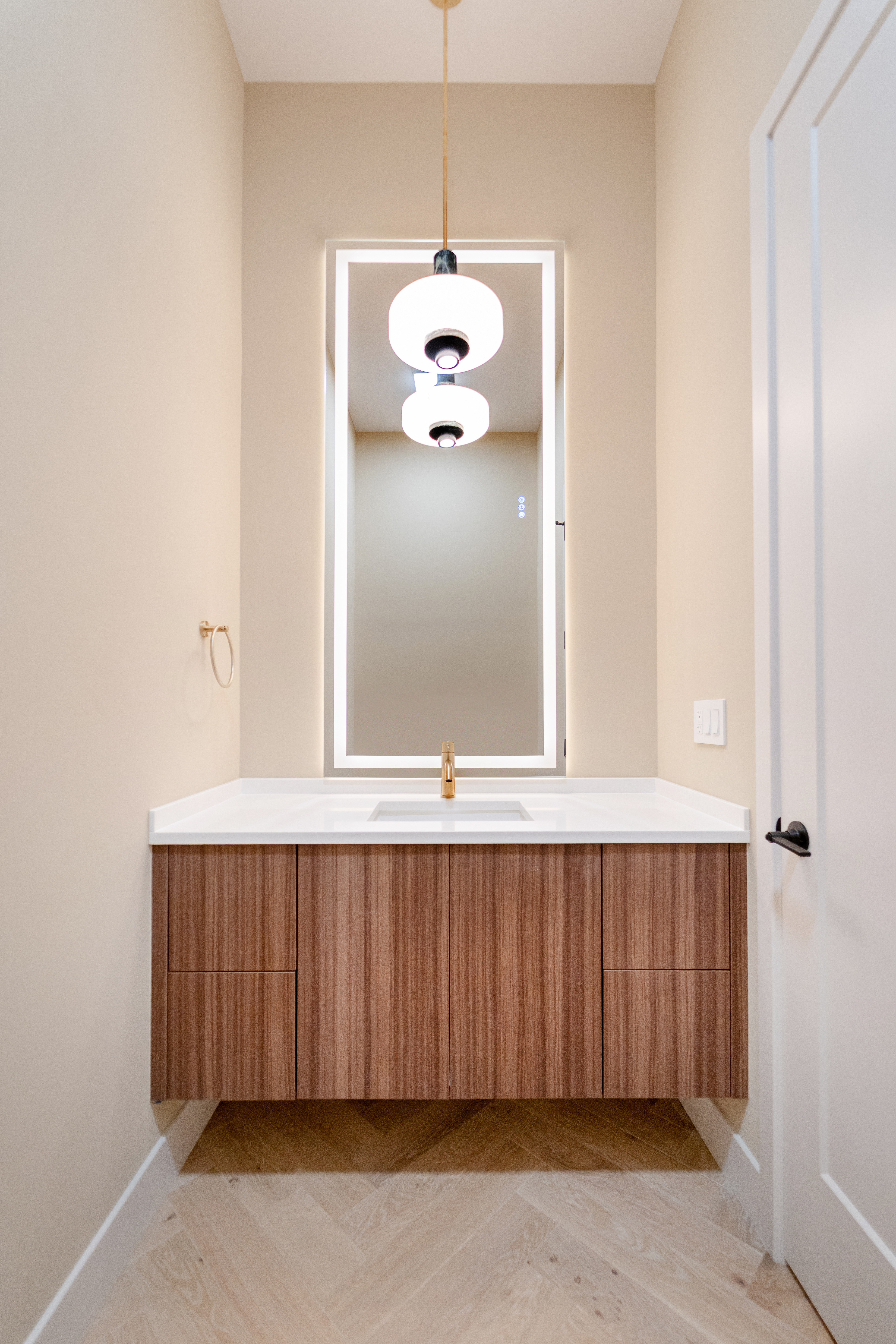 Powder room with floating walnut vanity
